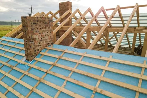 Roof framing and decking exposed during a Smart Roof Contracting replacement
